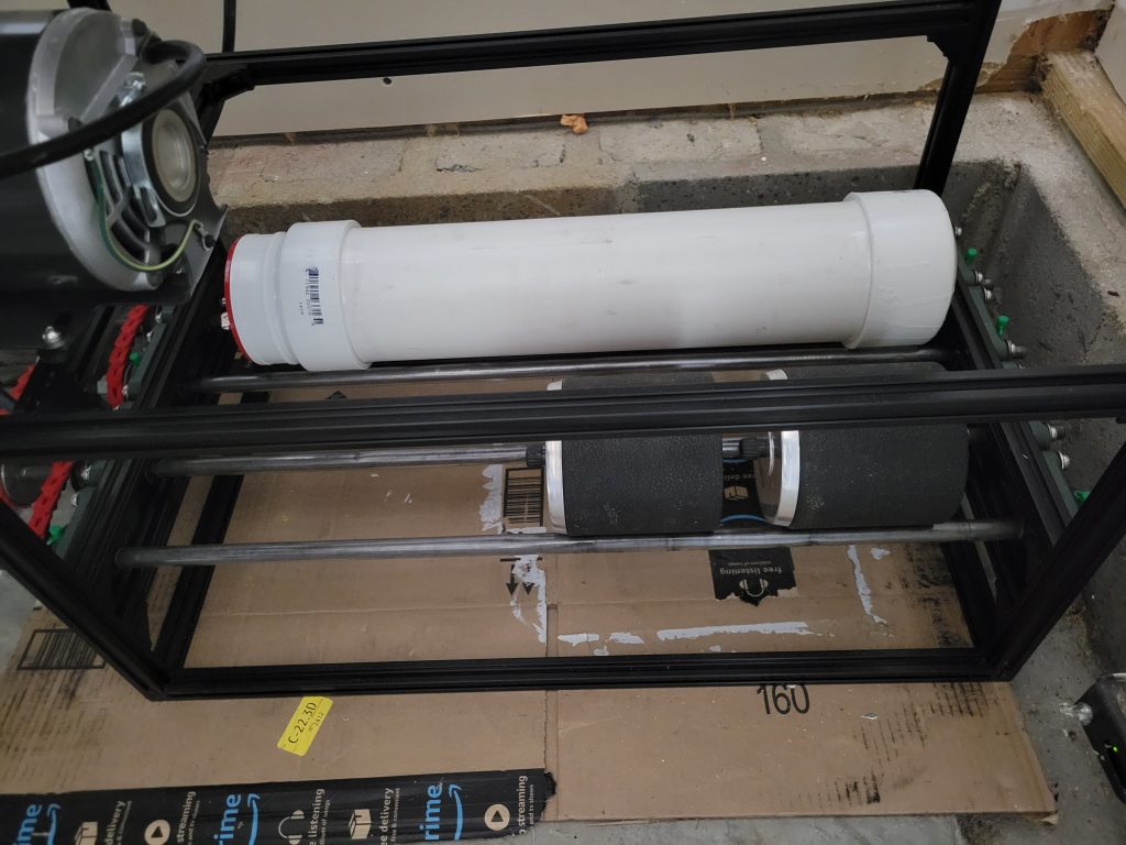 Finished custom rock tumbler with PVC barrel installed in a 2020 aluminum extrusion frame.
