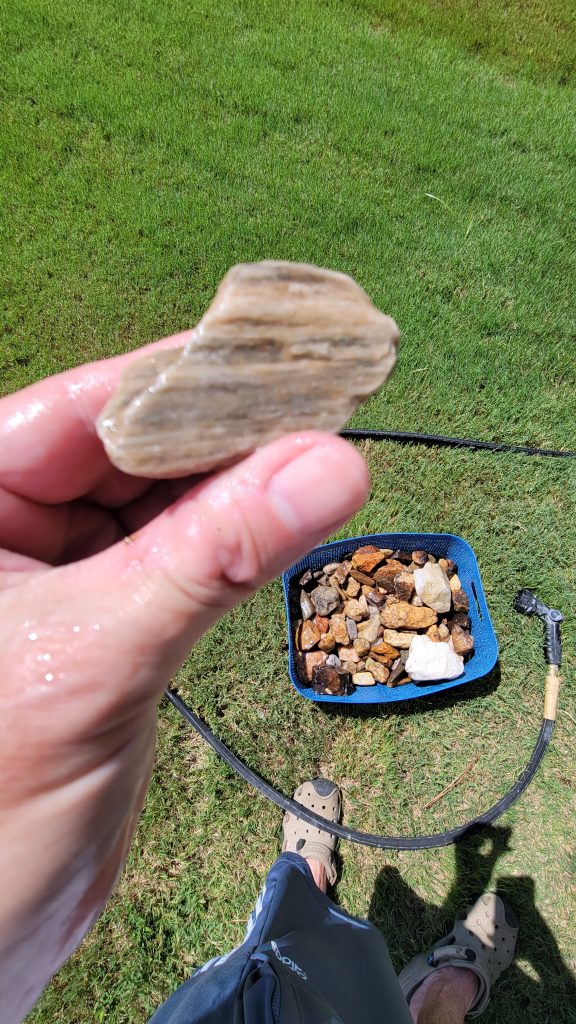 Polished rock held up after running through the custom rock tumbler.