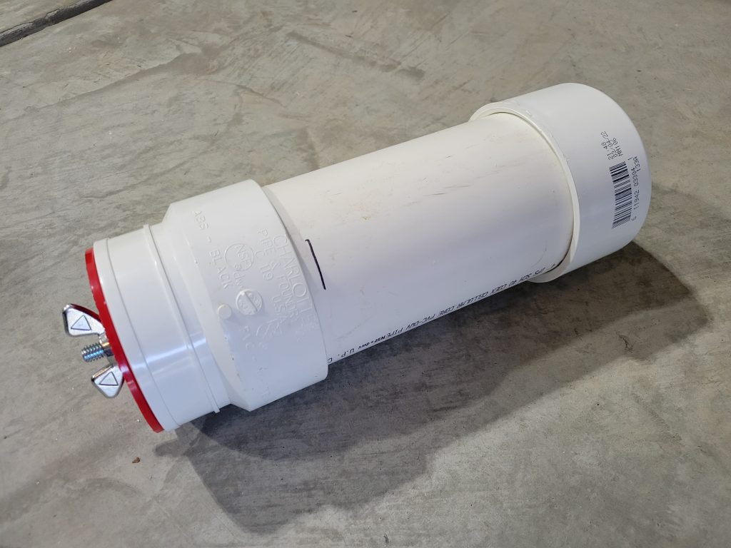 Custom PVC rock tumbler barrel assembled with a removable cap on one end.