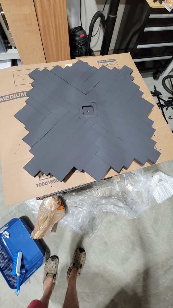 Back side of the assembled pine-strip clock face showing the structure
