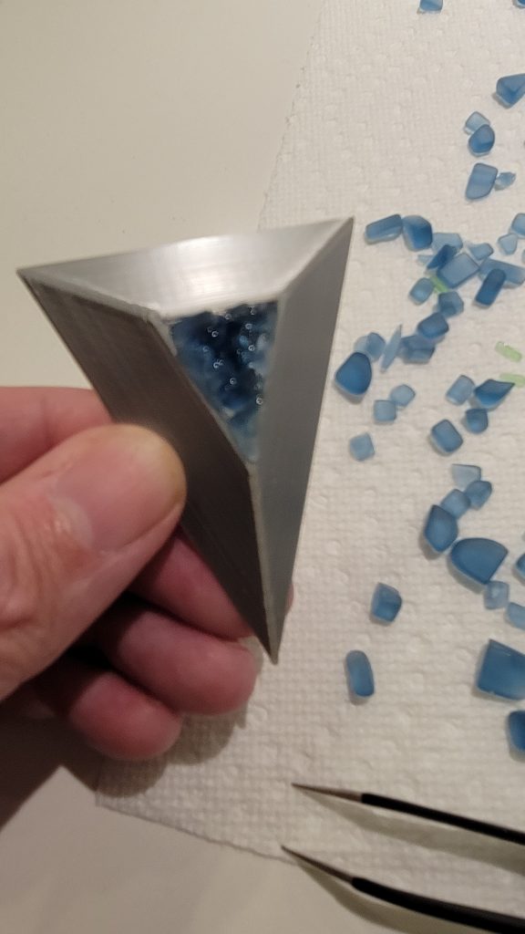 Blue sea glass pieces set inside a 3D printed triangular hour marker