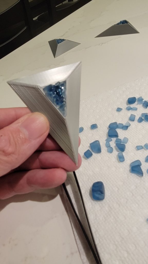 Close-up of handmade blue sea glass inside a 3D printed clock marker