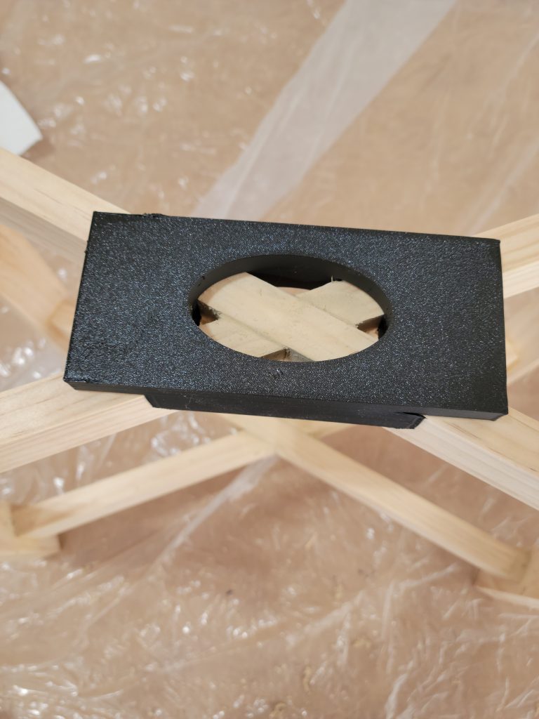 Black finish test on a frame part.