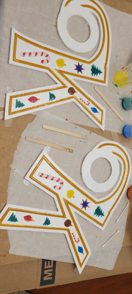 Painted monogram K clock parts with colored epoxy in the Christmas cutouts