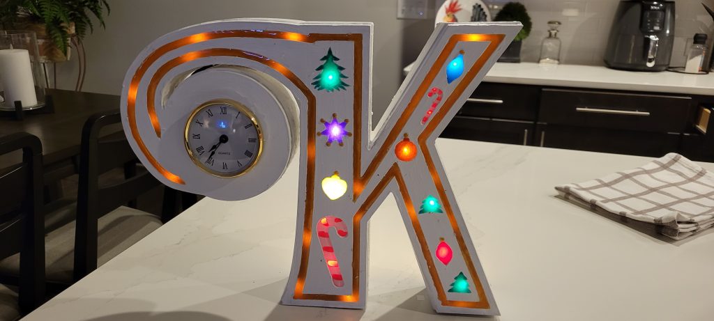 Finished monogram K Christmas clock with glowing epoxy shapes and integrated clock