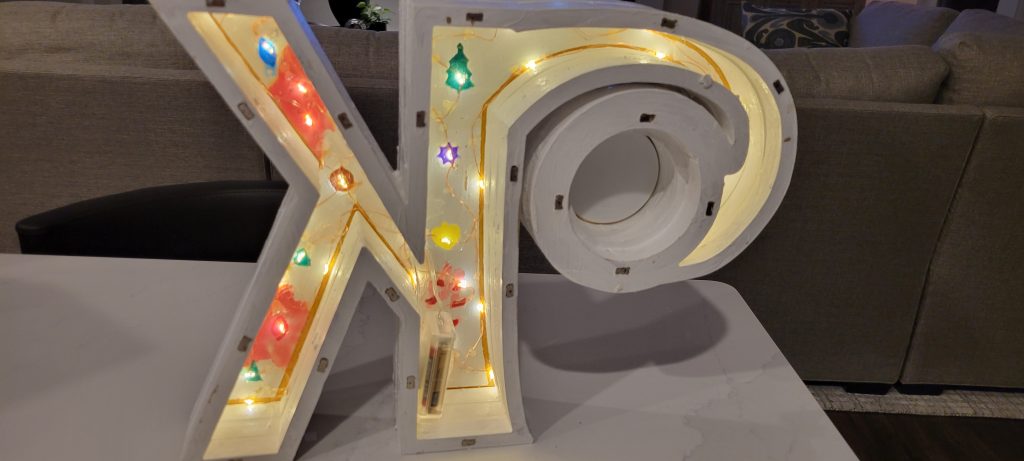 Back of the monogram K clock showing fairy lights, magnets, and battery access