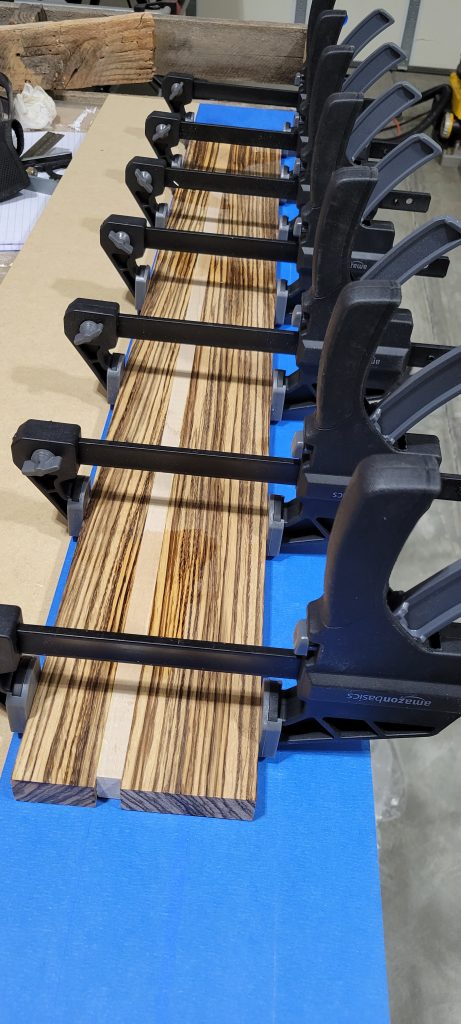 Zebrawood and maple strips clamped together during the box glue-up