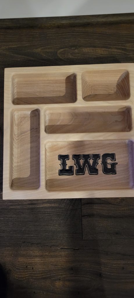 Top-down view of the monogrammed catch-all tray showing the pocket layout and rounded change pocket