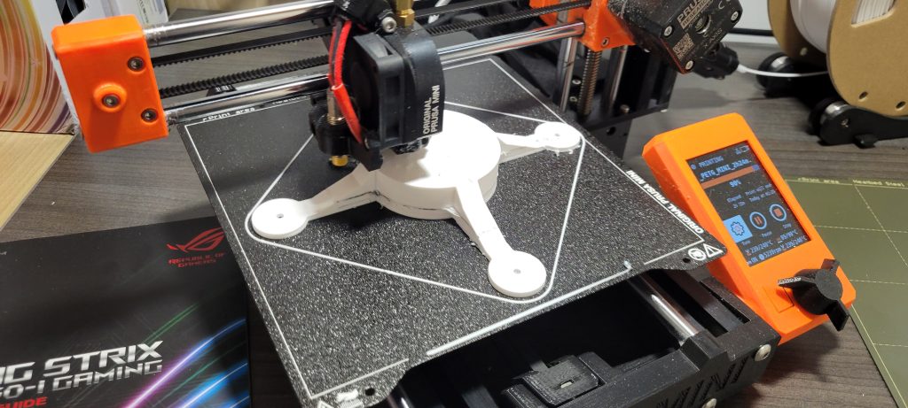 3D printed charger holder on the printer.