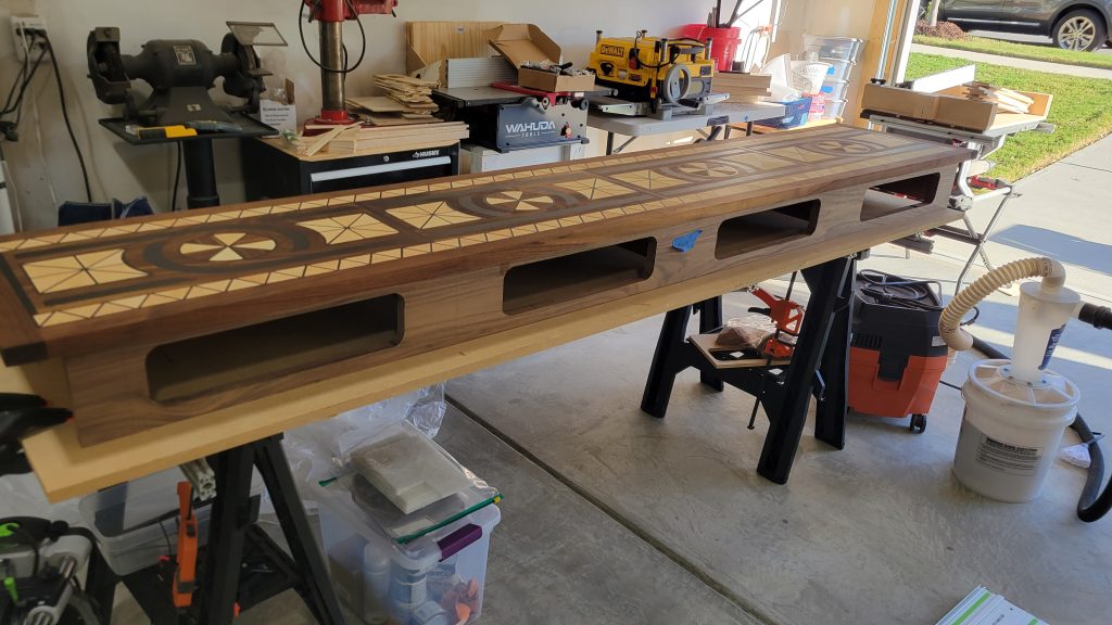 Walnut entry table case with the patterned top set in place during a shop test fit