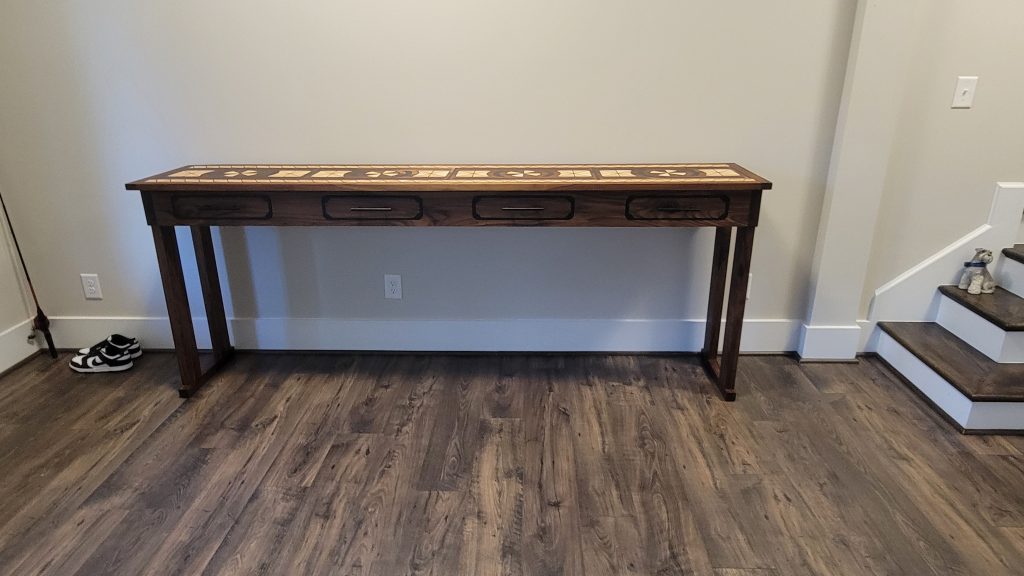 Finished eight foot walnut entry hall table installed against the entry wall