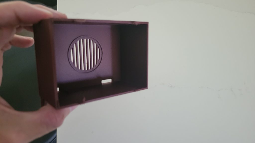 3D printed mini TV case shell showing the speaker grille before electronics were installed