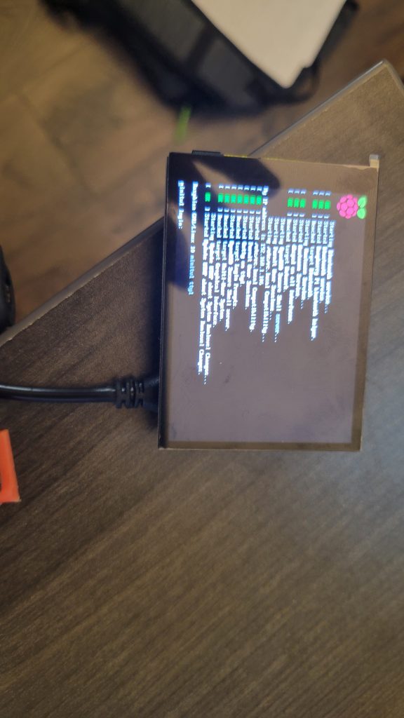 Loose LCD screen connected to the Raspberry Pi during an early boot test