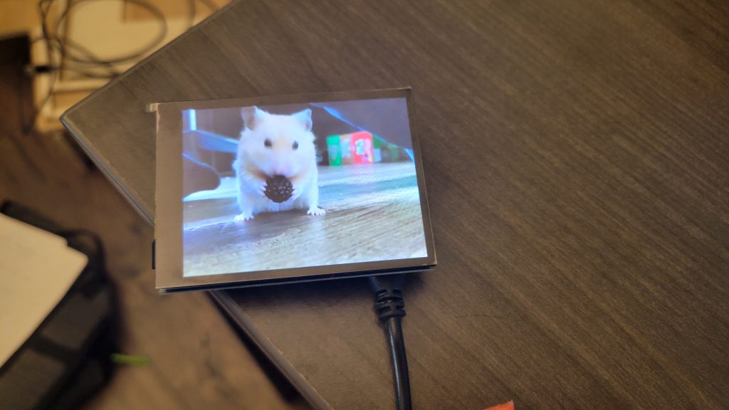 Loose LCD screen playing video during an early mini TV playback test