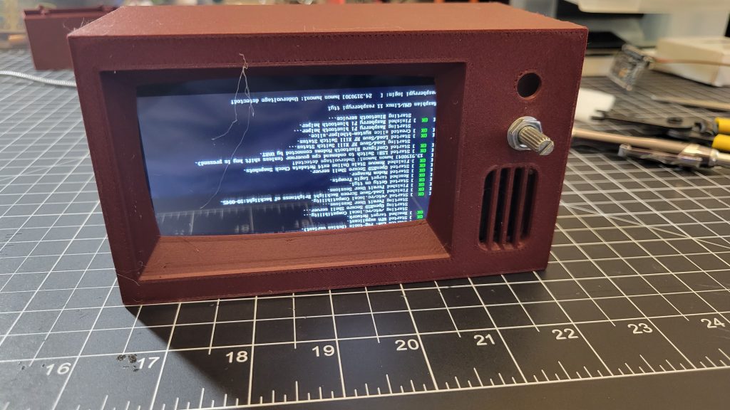 Mini TV case assembled around the LCD while the Raspberry Pi boots