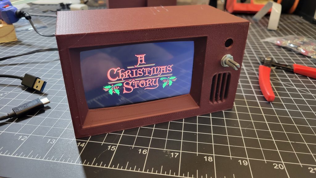 Assembled mini retro TV on the workbench playing a video loop