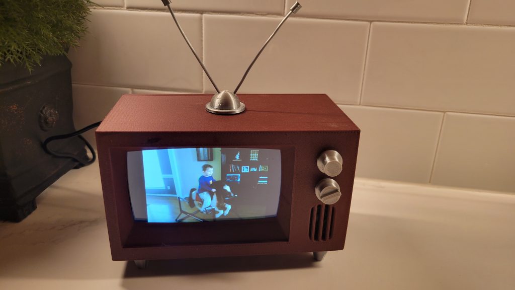 Finished mini retro TV in a home setting playing a personal video on its screen