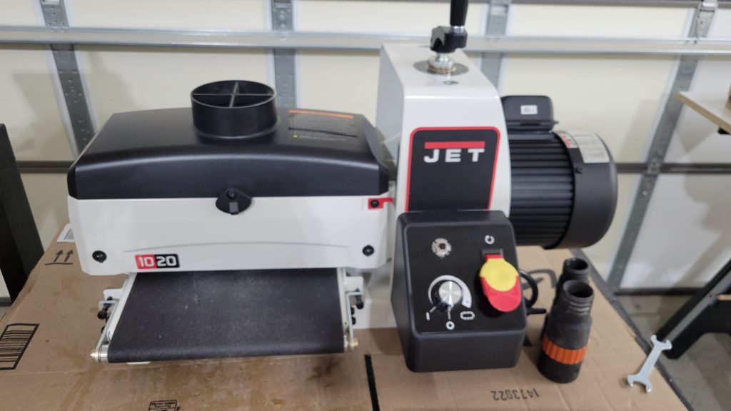 Drum sander set up in the shop for flattening the patterned panel.