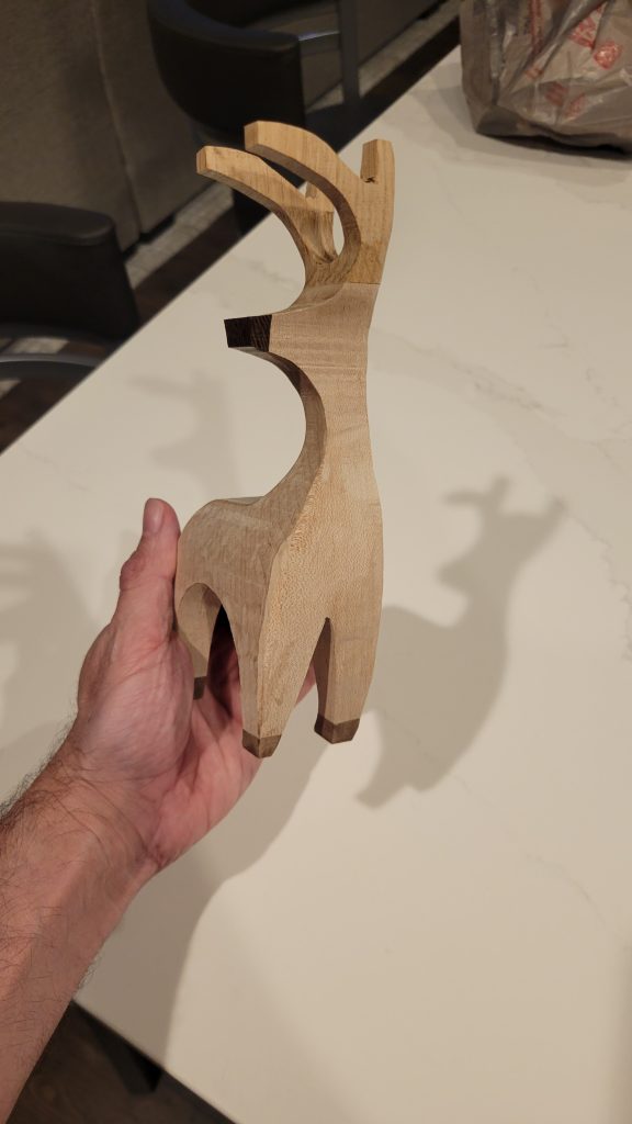 Side profile of a hardwood reindeer showing the compound-cut silhouette.