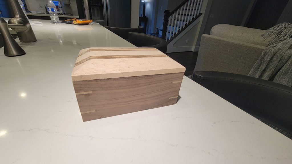 Rectangular scrap wood box showing light spline supports across the mitered corners.