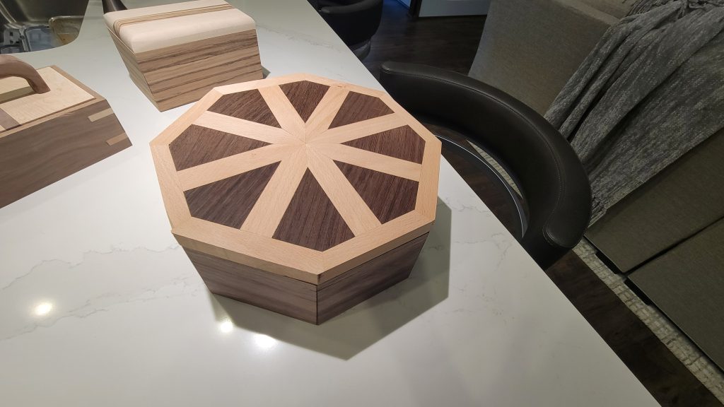 Octagonal wooden box with a contrasting radial pattern in the lid.
