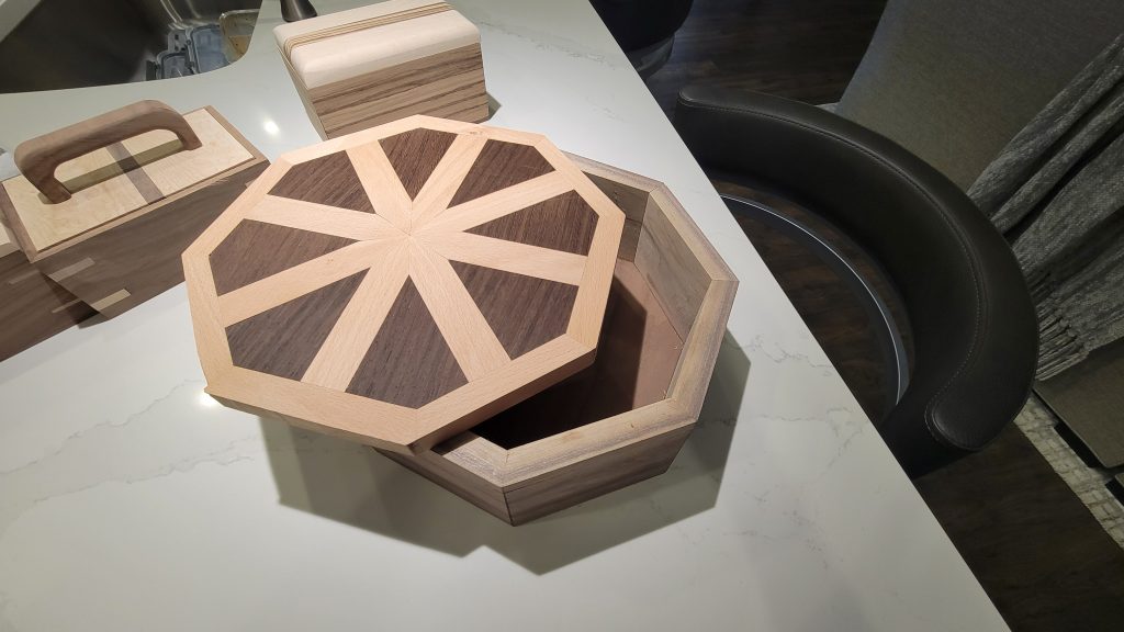 Finished scrap wood box tests with an octagonal box open in front.
