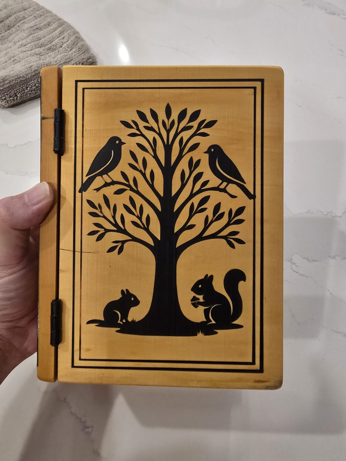 Finished yellowheart book-style 80th birthday box with black epoxy-filled tree engraving and black hinges.
