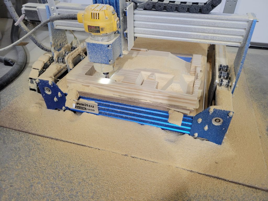 CNC router cutting layered parts for the custom birdhouse