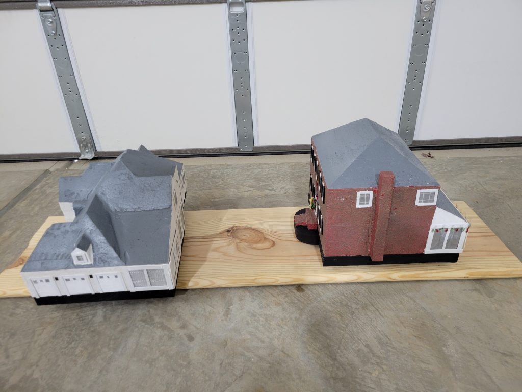 Angled view of the finished brick-style birdhouse showing roof, side wall, and chimney