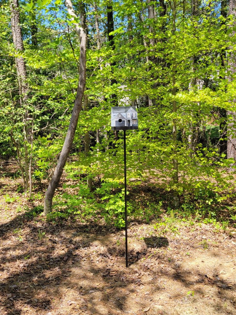 Paint and trim detail on the CNC-carved birdhouse