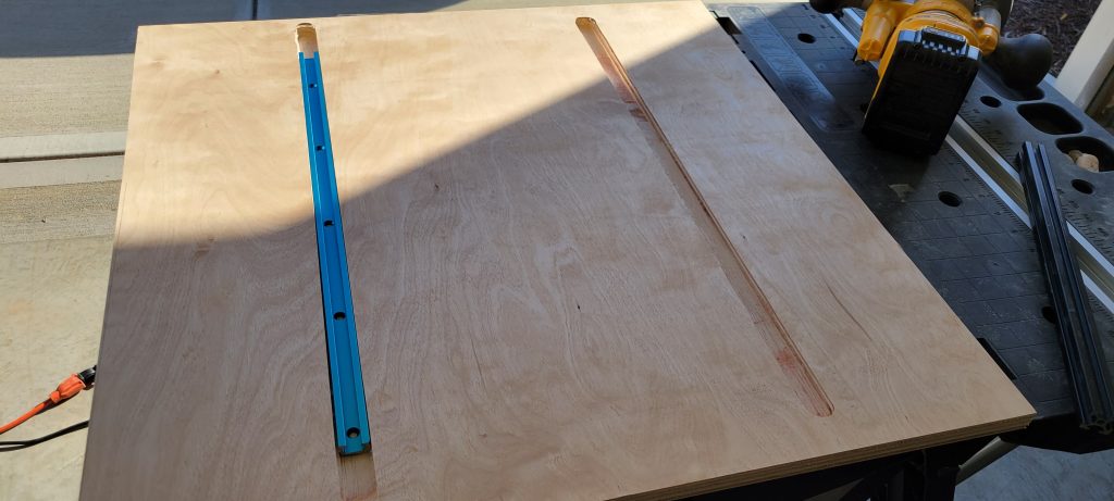 Blue T-track installed in the plywood crosscut sled base.