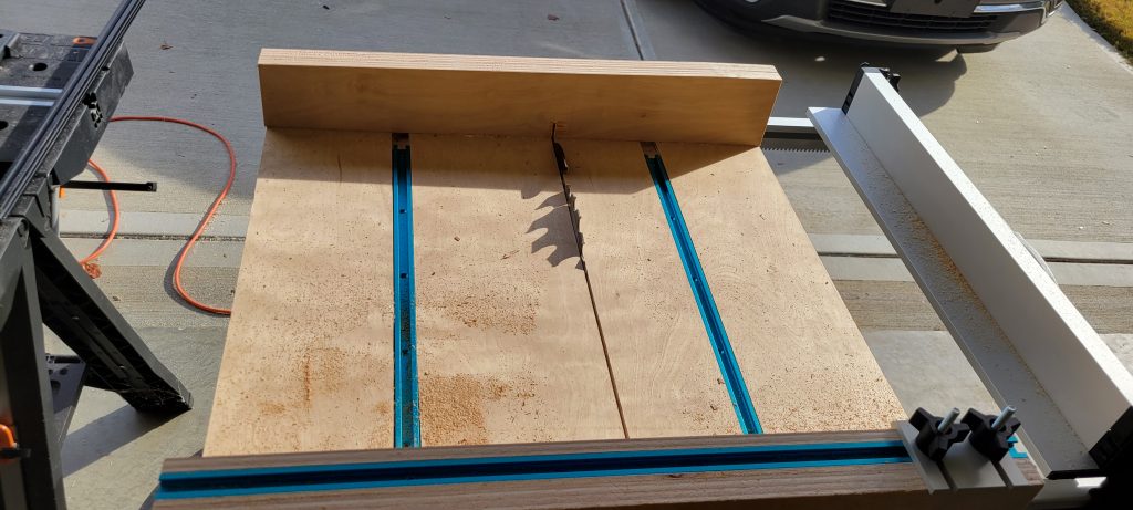 Crosscut sled supporting a workpiece during a cut.