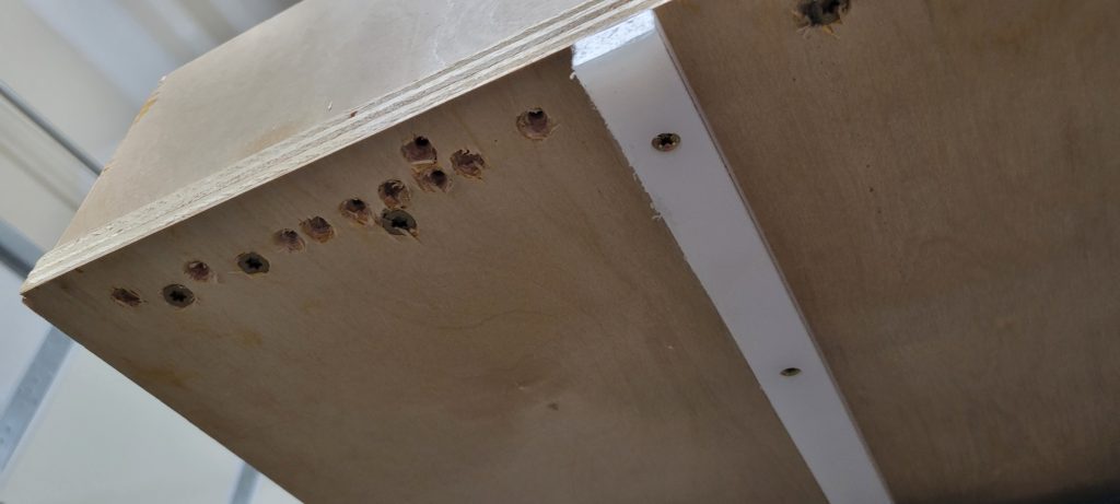 Underside of the crosscut sled showing runners and fasteners.