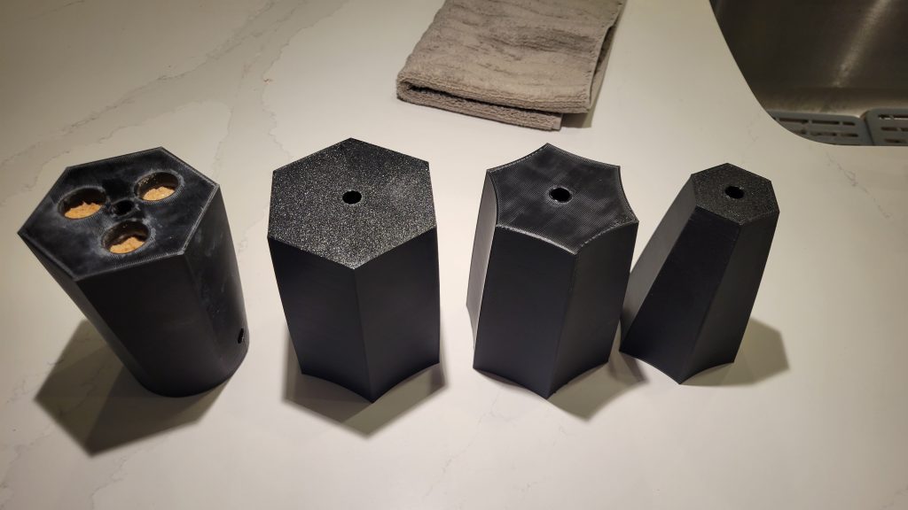 3D printed lamp body sections laid out before assembly.