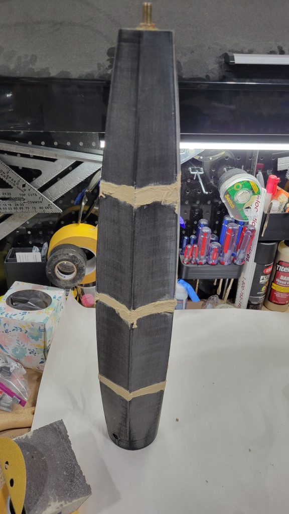 Lamp body seams filled with wood putty before sanding.