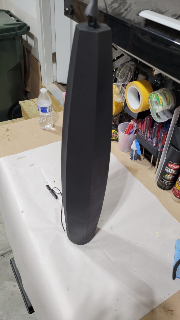Matte black painted lamp body with subtle edge highlights.