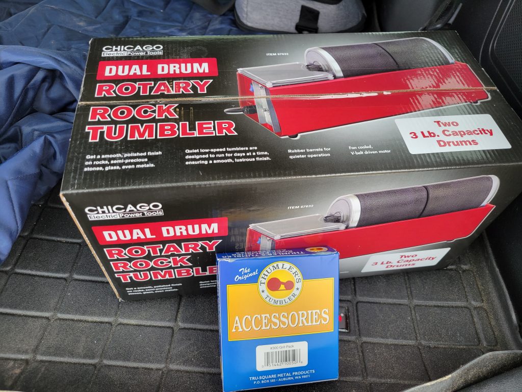 Harbor Freight dual drum rotary rock tumbler box and grit pack.